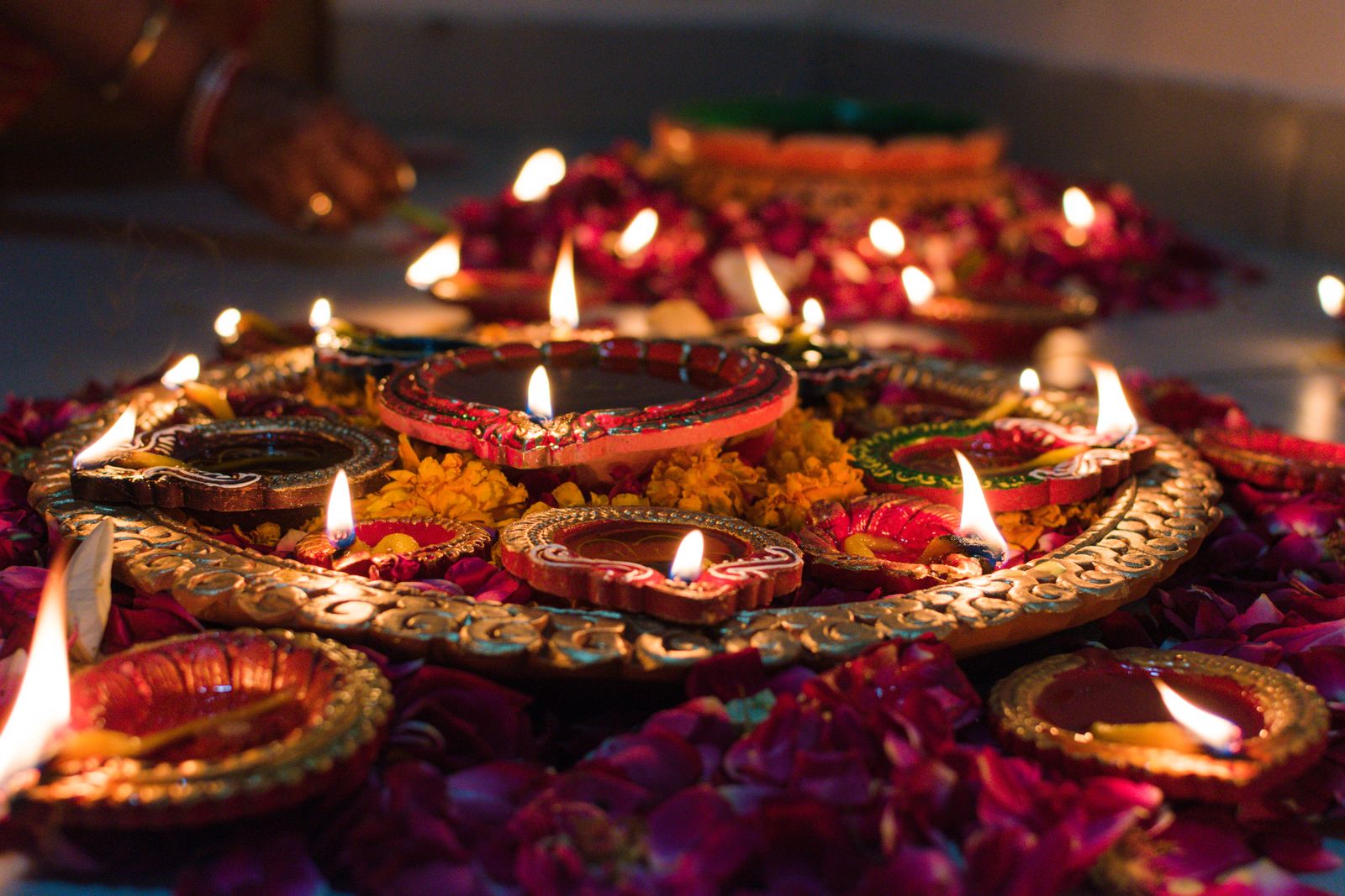Lit diyas with marigold flowers